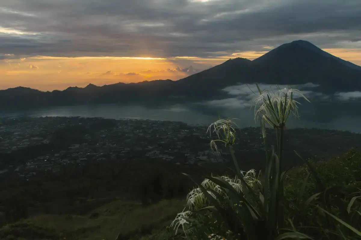 Sunrise over the Batur caldera, its lake and a volcanic peak, seen from Mount Batur